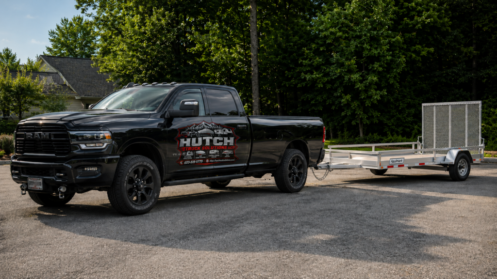 Hutch Truck Solutions boat hauling, camper hauling, junk removal, and residential snow plowing services in Southern New Hampshire